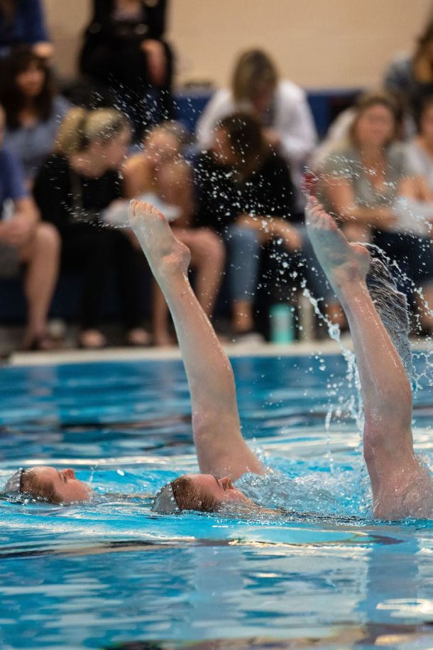Ravensong Waterdancers in pool with legs in the air doing routine