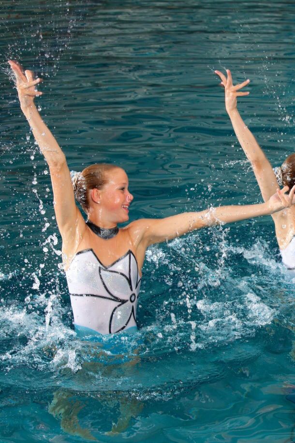 Two girls performing routine in the pool 