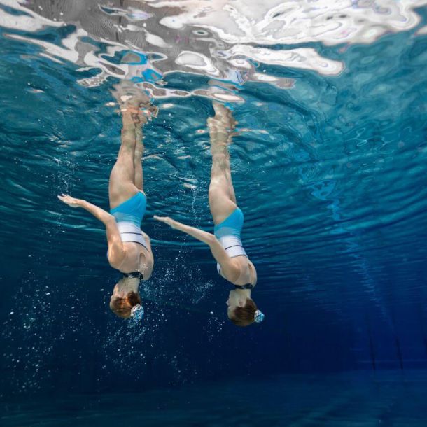 Duo of waterdancer girls underwater doing routine, duets program