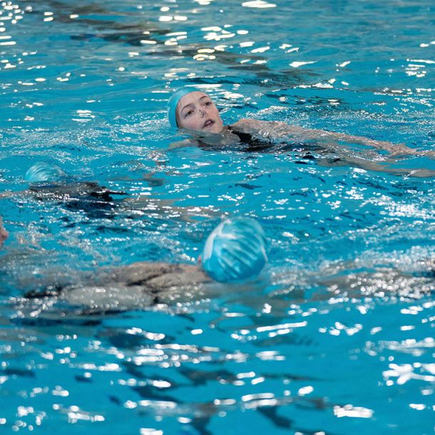 Duo of waterdancer girls in the pool doing routine, competitive stream program