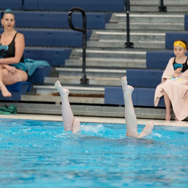Duo of waterdancer girls in the pool doing routine, duets program
