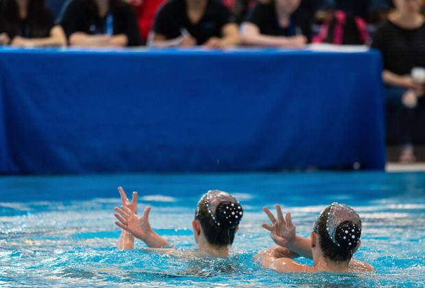 Two waterdancers performing in pool, Solo Duets Program